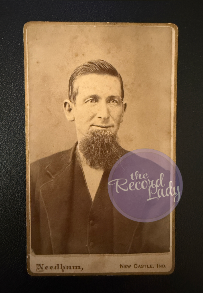 Sepia tone photo by Needham of a man with partial beard and short hair