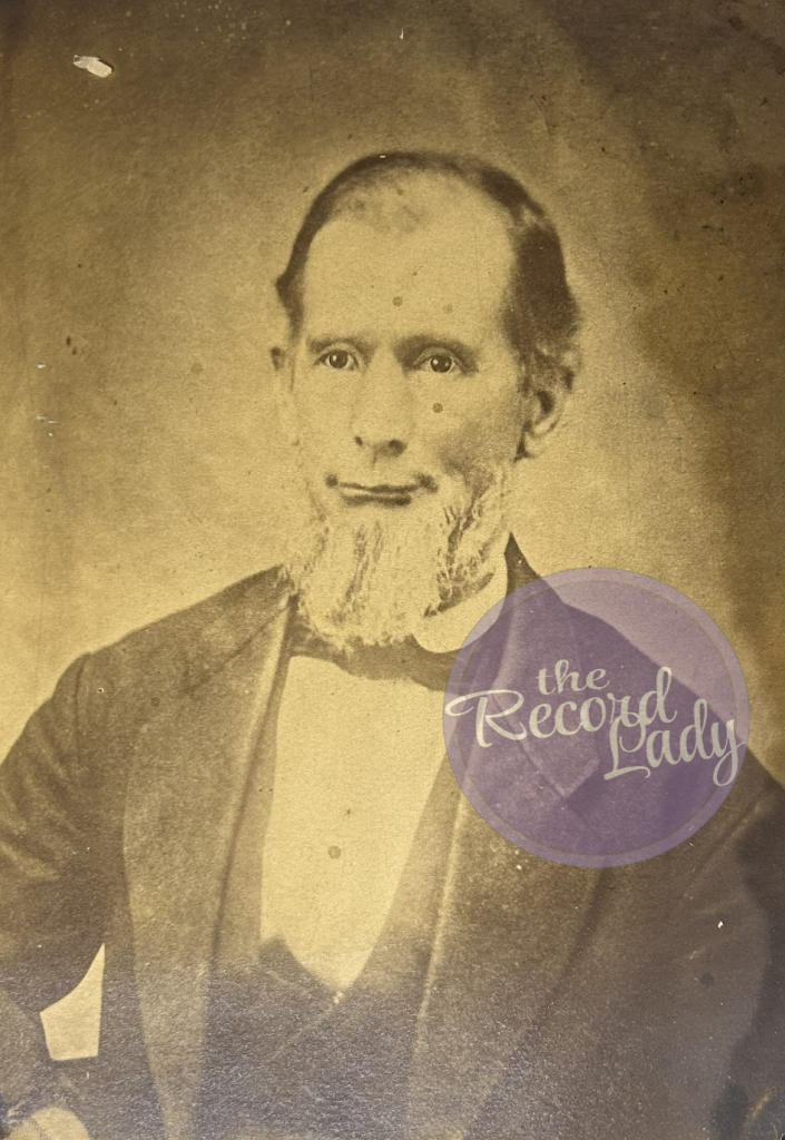 Man with white beard and clothing typica of the 1860s